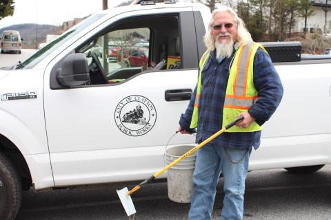 Megan Broome/The Clayton Tribune. Rob Hawsey picks up trash on Main Street in downtown Clayton with a grabber tool on Tuesday. He said that this and a broom are the materials he uses most for his job. Hawsey works for the city of Clayton as a street crew member under the Public Works Division. 