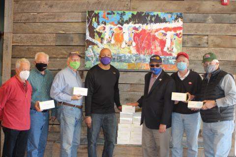 Megan Broome/The Clayton Tribune. Pictured are Rotarians Ray Pagano, Jef Fincher, Chip Goen, Food Bank Director James Brim, Rotary President Wayne Knuckles and Rotarians Matt Mitchum and David Tatum. 