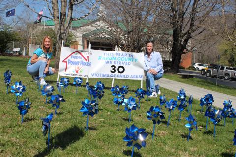 Megan Broome/The Clayton Tribune. Monica Blalock, director of community awareness for FAITH, left, and Caroline Wallis, executive director for FAITH, bring awareness of Sexual Assault and Child Abuse Prevention month with Pinwheels in front of the Rabun County Courthouse. 