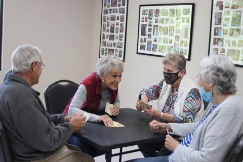 Megan Broome/The Clayton Tribune. Ronnie Balkcom, left, Nancy Phillips, Georgiann Wilson, and Peggy Thrasher play cards at the Rabun County Senior Center. The facility will open on Monday after being closed over a year due to the coronavirus pandemic.
