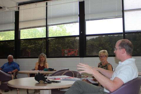 Megan Broome/The Clayton Tribune. Clayton DDA members Karen Bacon, vice chair, and Cassandra Clouser, board chair, listen to guest speaker Adam Hazell, planning director for the Georgia Mountains Regional Commission, talk about how to best organize their projects to make improvements to areas of downtown Clayton. 