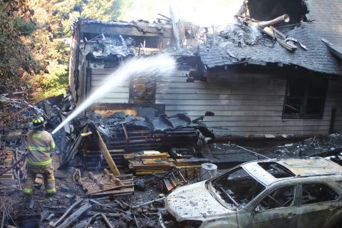 Megan Broome/The Clayton Tribune. Firefighters battle a blaze in the Vista Ridge Apartment Complex on Sunday.