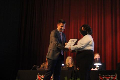 Megan Broome/The Clayton Tribune. RCHS Principal Justin Spillers, left, presents Abigail Page with an award in the auditorium of the Fine Arts Building on Senior Scholarship and Awards Night held on  May 11. 