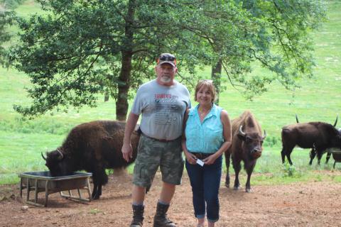 Megan Broome/The Clayton Tribune. Mike English, left, and Mary Serra are still searching for five of their missing bison after the herd wandered off of Tallulah Bison Ranch, a 48-acre farm located on Dandelion Ln. off of Persimmon Rd., on June 13. The couple has nine bison and are asking for help to locate the missing animals. 