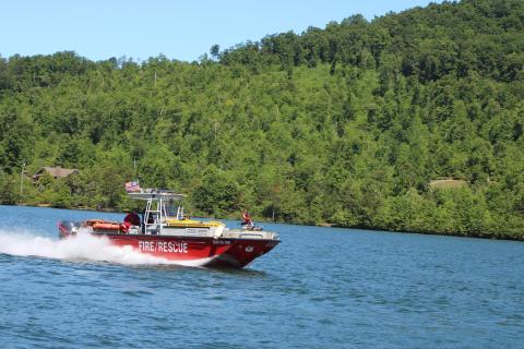 Megan Broome/The Clayton Tribune. The Rabun County Fire Services fire boat led the parade of wooden boats in the annual Lake Burton Wooden Boat Parade on Sunday. The boats set sail from Timpson Cove and made their way to LaPrade’s Marina where members of the public were invited to view the boats. 