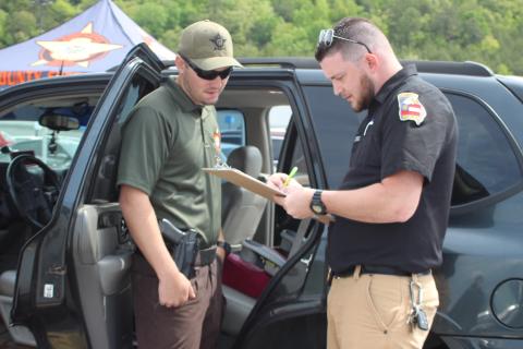  Megan Broome/The Clayton Tribune. Rabun County Sheriff's Office Patrol Corporal Clinton Scott, left, and Dillard Police Chief Jeremy Parker participated in a car seat inspection event at the Clayton Walmart recently where nationally certified technicians helped citizens properly install car seats and booster seats. The RCSO partnered with Safe Kids Rabun County for the event. Scott was one of five deputies who became certified as a Child Passenger Safety Technician (CPST).