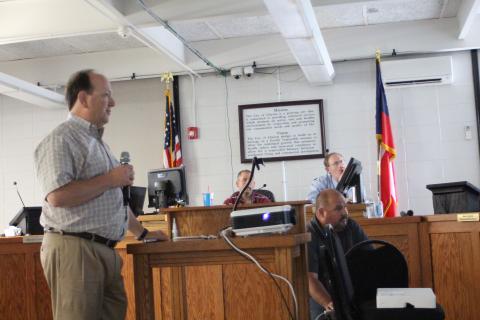 Megan Broome/The Clayton Tribune. Eric Neese, engineer for the city of Clayton, gives a presentation to Clayton council members at Tuesday’s meeting to discuss discrepancies in the billing cycle when the RCWSA billed the city twice in their April water bill. The city initially received an April bill of $85,000 and shortly after received a bill for April for an additional $26,000.