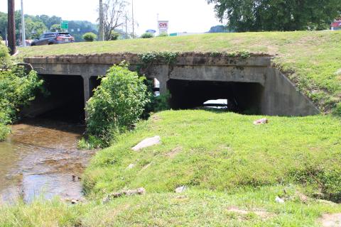 Megan Broome/The Clayton Tribune. A blocked culvert that channels Stekoa Creek under Chechero St. is obstructing the start of a green infrastructure rain garden project spearheaded by Chattooga Conservancy. The culvert has to be unblocked by city of Clayton officials before the rain garden project can begin. 