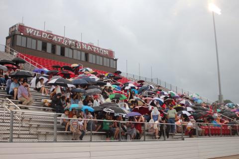 Megan Broome/The Clayton Tribune. Friends and family members of graduates brave the wind and rain to watch the Class of 2021 graduate. The ceremony had to be moved inside shortly after due to rain and threats of lightning strikes in the area. 