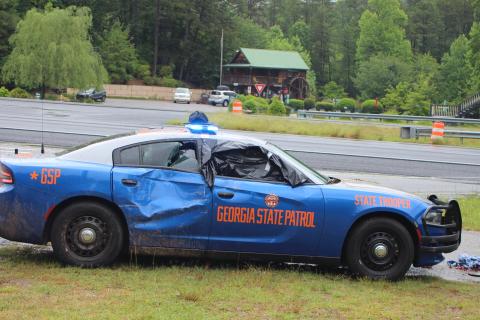 Megan Broome/The Clayton Tribune. A Georgia State Patrol vehicle was struck by a vehicle that first struck an embankment following a maneuver by GSP to stop a suspect after he fled from a traffic stop on Ga. 15 near Lofty Branch Rd. in Rabun County Monday morning. The suspect was pursued by GSP before crashing his vehicle and fleeing the scene on foot. 