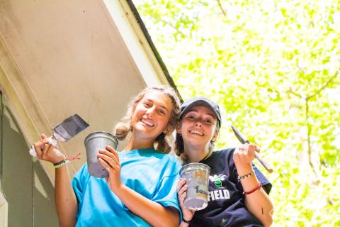 Submitted photo. Youth members of St. Ann’s Parish in Marietta, Ga. paint a home as a project for the Restore Mission Week with the Life Teen movement at Camp Covecrest recently.. 