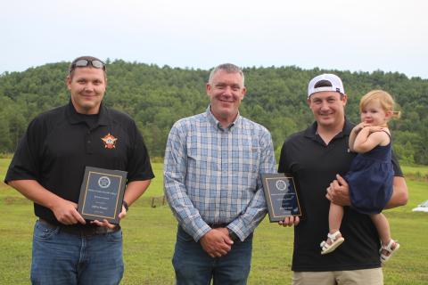  Megan Broome/The Clayton Tribune. Sheriff Chad Nichols, center, presents the Bravery Award to Deputy Jeffrey Hooper, left, and the Life Saving Award to Deputy Brandon Hyer for their roles in going above and beyond their normal duties to help citizens and save lives. Hyer holds his daughter, Blakely Hyer.