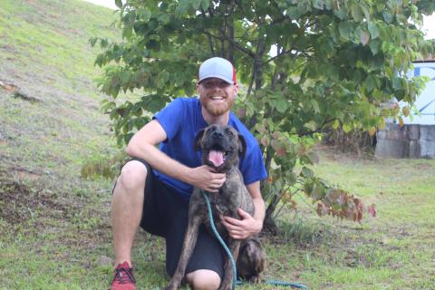 Megan Broome/The Clayton Tribune. Everett Lampros, public relations representative for Paws 4 Life, poses with Eugene, a boxer/hound mix and brindle who’s been at Rabun Paws 4 Life since August 22, 2017. Eugene is looking for his furever home after being rescued from a neglect situation where he was malnourished from inadequate food and water. 