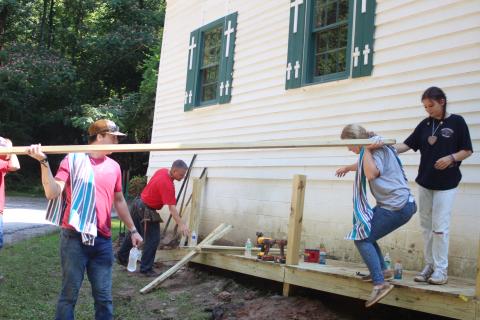 Megan Broome/The Clayton Tribune. Will Davis, left, Rev. Lee Krivsky, pastor at New Hope United Methodist Church, back, Stella Merkle and Hannah Hickox work to build a ramp to improve accessibility at New Hope United Methodist Church last month as part of the Rabun Aid Program (RAP). 