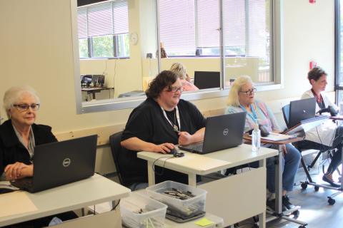 Megan Broome/The Clayton Tribune. Poll workers Ann D'Agostino, left, Amanda Burrell, Sandra Wood and Kay Townsend check in advance voters.
