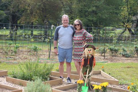 Megan Broome/The Clayton Tribune. Mark and Michelle Edwards tour the Old School Garden during its annual plant sale last Saturday. 