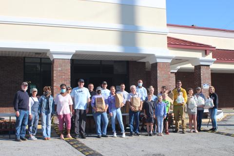 Megan Broome/The Clayton Tribune. Law enforcement officers, volunteers from Fight Abuse in the Home (FAITH) and local churches participated in the Faith and Blue event last Saturday at the Food Bank of Northeast Georgia. 