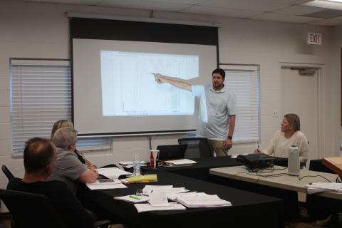 Megan Broome/The Clayton Tribune. Brian Irvin, left, presents renderings of what a short-term rental development planned for Tallulah Falls is expected to look like to zoning board members last Thursday.