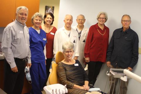Megan Broome/The Clayton Tribune. Marcia Ranney sits in the new dental chair at the Community Dental Clinic which operates under the Clayton Rotary Foundation, Inc. The chair along with other supplies were provided from a $10,000 grant from the Lake Burton Civic Association Foundation. Also pictured are (from left) Tim Ranney, Sherry Spurr, Amy Hulett, Dr. Brian Davis, Dr. Tom Callahan, Jane Janes, and Jim Wallis from the Lake Burton Civic Association.