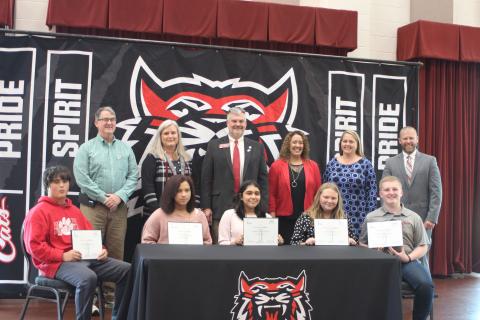 Megan Broome/The Clayton Tribune. Back row: Scott Poss, REACH community partner, superintendent April Childers, Victor Anderson, Georgia State House of Representatives, RCMS principal Kechara Partin, assistant superintendents Kelly McKay and Matt Remillard. Front row: Bobby “Zach” Gordon, left, Vivian Fisher, Sofia Luna Lopez, Alyssa Stancil, and Clayton Scott. 