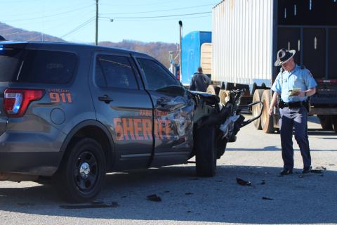 Megan Broome/The Clayton Tribune. A Georgia State Patrol trooper investigates the damage to the Rabun County Sheriff’s Office vehicle. The deputy driving to a scene was not injured in the crash.