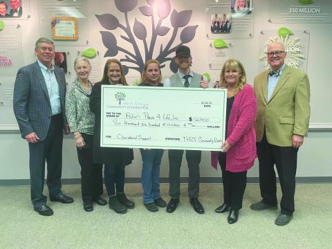 Photo submitted courtesy Margaux Dolenc. North Georgia Community Foundation board member Rob Fowler (from left); Debbie Dalhouse, Paws 4 Life volunteer; Jennifer Marcellino, Paws 4 Life CEO; Becca McClain, shelter director; Everett Lampros, shelter public relations manager; and Robert Shippey and Linda Foster, North Georgia Community Foundation board members, pose with a $6,619 North Georgia Community Foundation Grant check awarded to Paws 4 Life. 