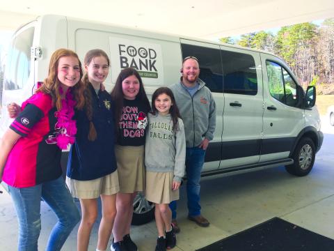 Photo courtesy of Tallulah Falls School. A food drive led by seventh-grade students at Tallulah Falls School generated more than 900 cans for the Food Bank of Northeast Georgia. Shown (from left) are seventh-graders Gracey Eller of Clarkesville, Megan Prince of Rabun Gap, Caylin Tucker of Demorest, Avery Keim of Clarkesville and FBNG Warehouse Coordinator Philip Wilkes. 