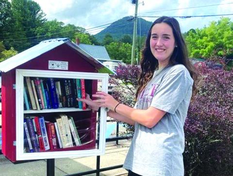 Submitted photo. Community Service -- Donations to Book Box at Tiger, Post Office  Shown with the books location is FBLA member Emily Dugas.