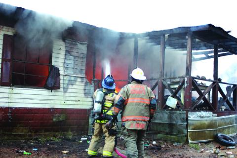 Megan Broome/The Clayton Tribune. Rabun County Fire Services work the scene of a structure fire at 453 Dan Crane Rd. Tuesday. No injuries were reported. The cause of the fire is under investigation. 