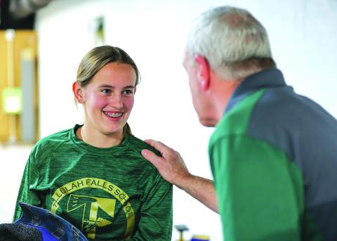 Photo courtesy Austin Poffenberger. Tallulah Falls freshman Kylee Loudermilk talks with Rifle Program Head Coach Tim Stamey during the Indians’ win against Dawson County.