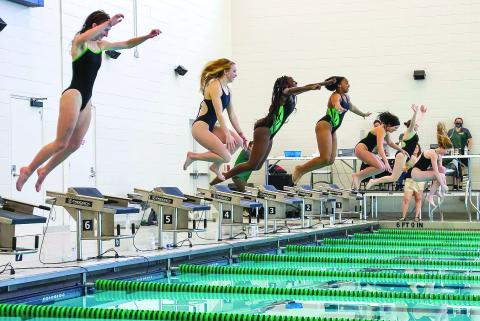 Photo courtesy of Austin Poffenberger. Emily Wolfe (from left), Karis Tatum, Daya Ssemakula, Tamia Moss, Hannah Hickox, Tillie Crumley and Montgomery Dampier jump into the pool after winning the girls’ 1A swimming championship.