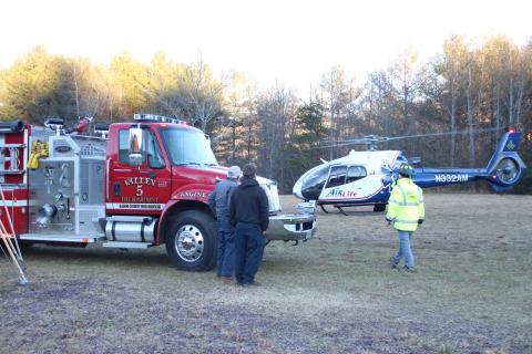 Megan Broome/The Clayton Tribune. A man was transported by Air Life helicopter Tuesday afternoon after attempting to stomp out a brush fire in a filed near the intersection of Highway 246 and Lamb Rd. 