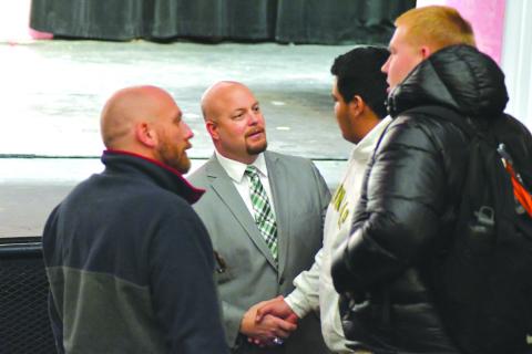 Enoch Autry/The Clayton Tribune. New Rabun Gap-Nacoochee head football coach Derek White (center) talks with his Eagle student-athletes Tuesday morning during an introduction ceremony at the school. White comes to RGNS after guiding five state-title winning football programs.
