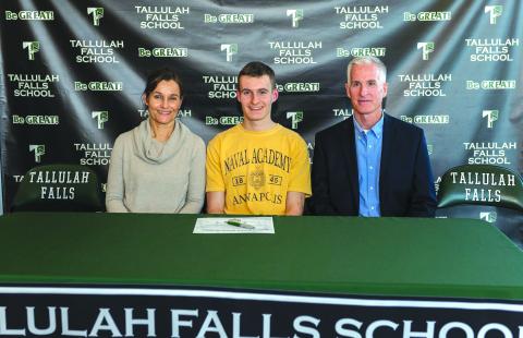 E.Lane Gresham/Tallulah Falls School. Tallulah Falls senior Evan Prince signed a national letter of intent with the U.S. Naval Academy Tuesday with his parents Debbie and George next to him.