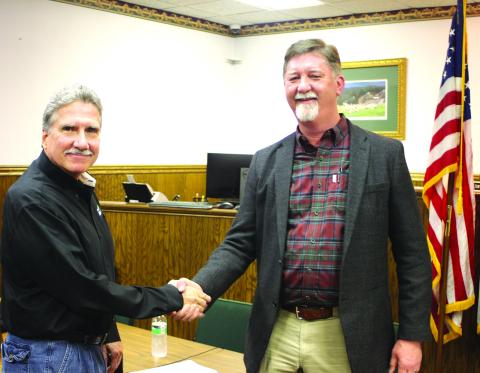 Megan Broome/The Clayton Tribune. After the Rabun County commission and Clayton city council unanimously vote Feb. 17 on a Service Delivery Strategy agreement, Commission Chair Greg James and Clayton Mayor Kurt Cannon shake on the decision.