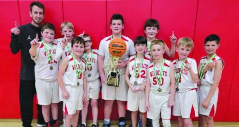 Submitted photo. The Rabun County 10-and-under boys recreation department basketball team won the county's first state Georgia Recreation and Park Association state championship on March 5. Pictured are the winning players and their trophy with Coach David Adcock. Not pictured is Coach Kristina Burrell.