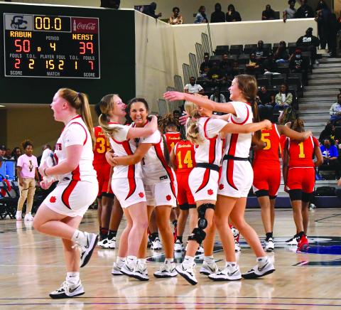 As the final seconds tick off the clock, the Rabun County fans and Ladycat bench come to their feet to celebrate the girls’ 50-39 Class AA Final Four victory as freshman Jacie McCall (14) even shows off her biceps. RCHS plays Elbert County March 10 for the state title.