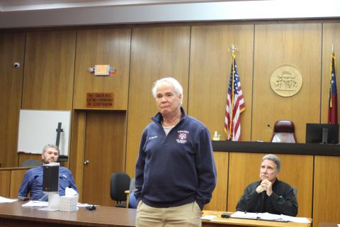 Megan Broome/The Clayton Tribune. Firefighter Gordon Van Mol addresses fellow first responders and attendees during a presentation at the Rabun County Board of Commissioners meeting Feb. 22 and thanks them for saving his life after he went into cardiac arrest while battling a brush fire Nov. 27. The first responders were presented with plaques for their heroic efforts. “These people are at their best when you are at your worst,” a tearful Van Mol said. 
