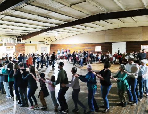 Megan Broome/The Clayton Tribune. Locals and people in neighboring communities came out for the soft opening of the Mountain City Playhouse on March 12. Attendees do the "bunny hop" among a crowd that was standing room only at the venue. 