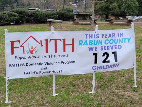 Megan Broome/The Clayton Tribune. April is National Child Abuse Awareness Month and a banner is displayed at the Rabun County Courthouse bringing awareness to the issue and show that 121 children in Rabun County were served by F.A.I.T.H this year. 