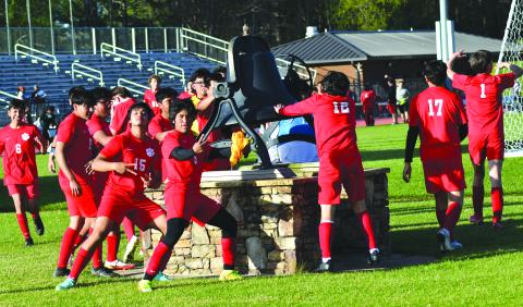 Enoch Autry/The Clayton Tribune. The Wildcats ring the bell after winning the state tourney game.
