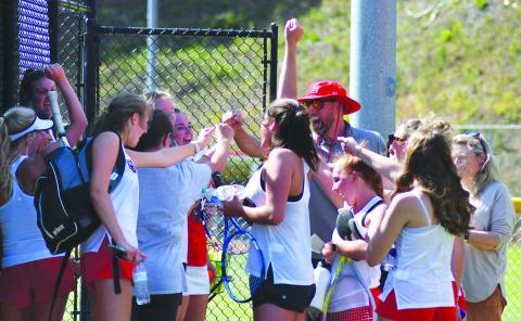 Enoch Autry/The Clayton Tribune. With RCHS head coach Bryan Getty, the Ladycat tennis team celebrates its 3-1 win over visiting Bacon County to advance to the Class AA Elite Eight. RCHS plays at fellow No. 1 seed Berrien Monday morning. 