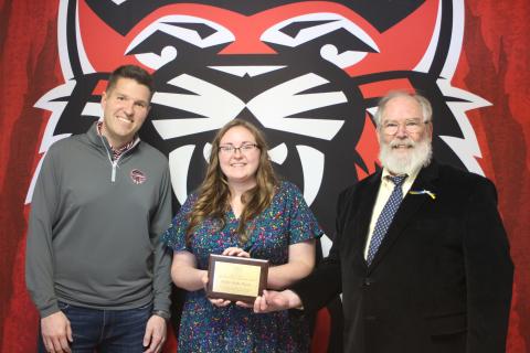 Megan Broome/The Clayton Tribune. RCHS teacher and UNG graduate student Kelsie Burks Mayes, center, is presented with the Appalachian Studies Association 2021 Carl A. Ross Appalachian Graduate Student Paper Award by Dr. Barry Whittemore, lecturer at UNG. RCHS Principal Justin Spillers stands to the left. 
