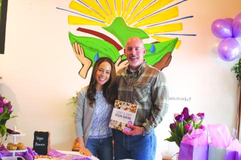 Megan Broome/The Clayton Tribune. Jillian Glenn, who has the blog “Peanut Butter & Jilly,” poses with her father Roger Glenn at her book signing for her second title “Light & Easy Vegan Baking,” held at the Holistic Mountain Market in Clayton on April 16.  Her first book “Easy Low Cal Vegan Eats” has recipes for every meal of the day. 