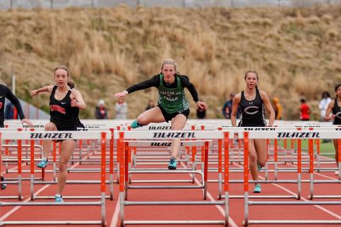 Photo by Austin Poffenberger. Macy Murdock clears the 100-meter hurdles for the Lady Indians.