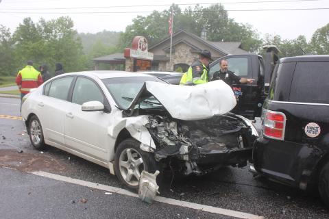 Megan Broome/The Clayton Tribune. Law enforcement officials inspect the damage from a three-vehicle crash that occurred in Dillard Monday.