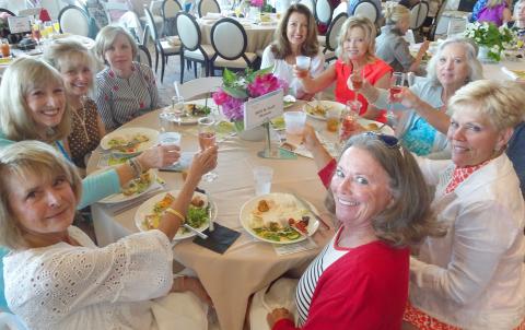 Jenifer Kulow/The Clayton Tribune. Community members toast to spending time together at the F.A.I.T.H. Fairways and Fashions event.