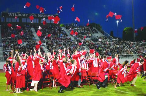 Enoch Autry/The Clayton Tribune. The Rabun County High School graduates of the Class of 2022 throw their caps into the air at the May 27 ceremony at Frank Snyder Memorial Stadium and race to the bell. 