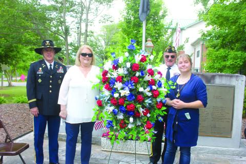 Megan Broome/The Clayton Tribune. Roger Glenn, United States Army Military Police Officer, Cindy O’Neil, Chris Dinofrio and Crystal Zajdowicz Cross place a wreath in honor of the men and women who fought and died for our country. Glenn was the speaker at the event. 