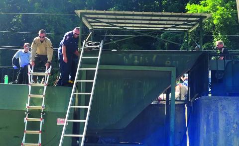 Megan Broome/The Clayton Tribune. Rabun County first responders work to rescue a woman who fell into a trash compactor while working at the Chechero Recycling Center Monday. 
